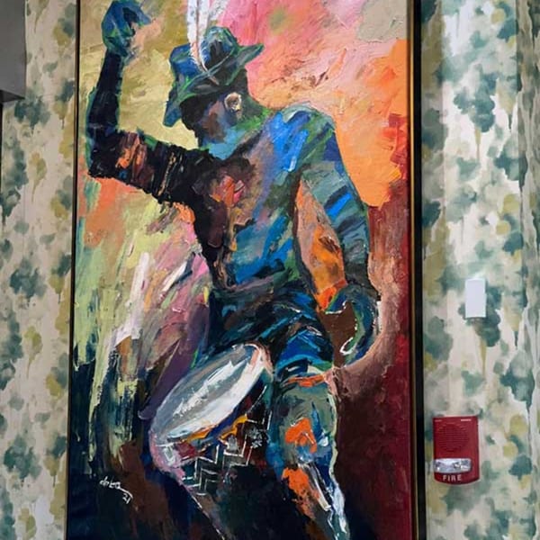 Vibrant, abstract painting of a person in a hat playing a drum, with a fire alarm on the wall.