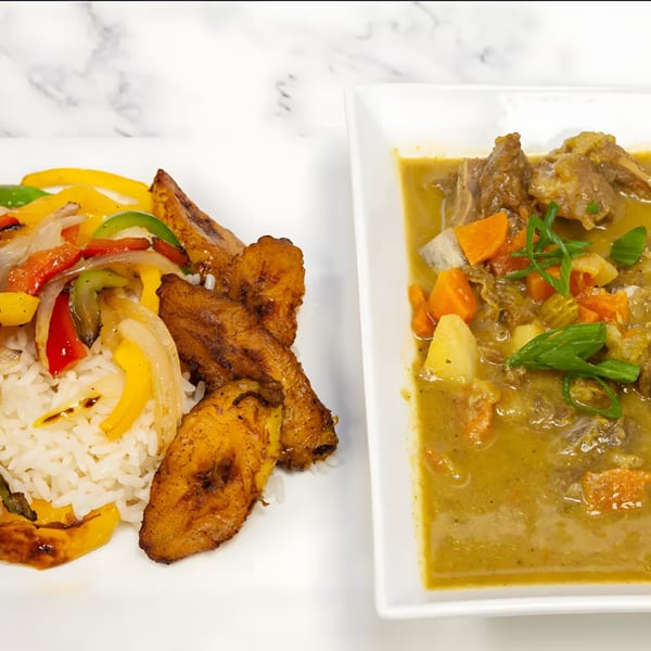 African curry with meat and vegetables, alongside rice, fried plantains, and sautéed peppers and onions.