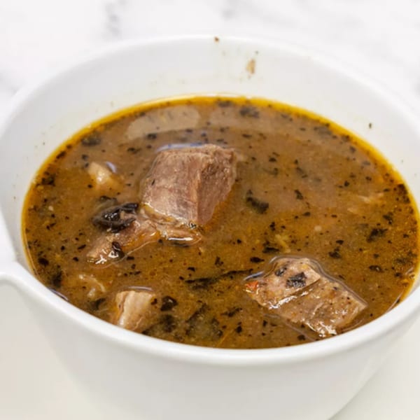 Aroma Restaurant & Lounge's African stew with meat chunks in a white bowl.