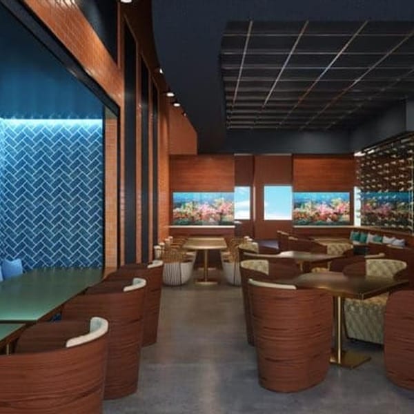 Modern restaurant interior with wooden tables, chairs, aquariums, and blue tiled walls.